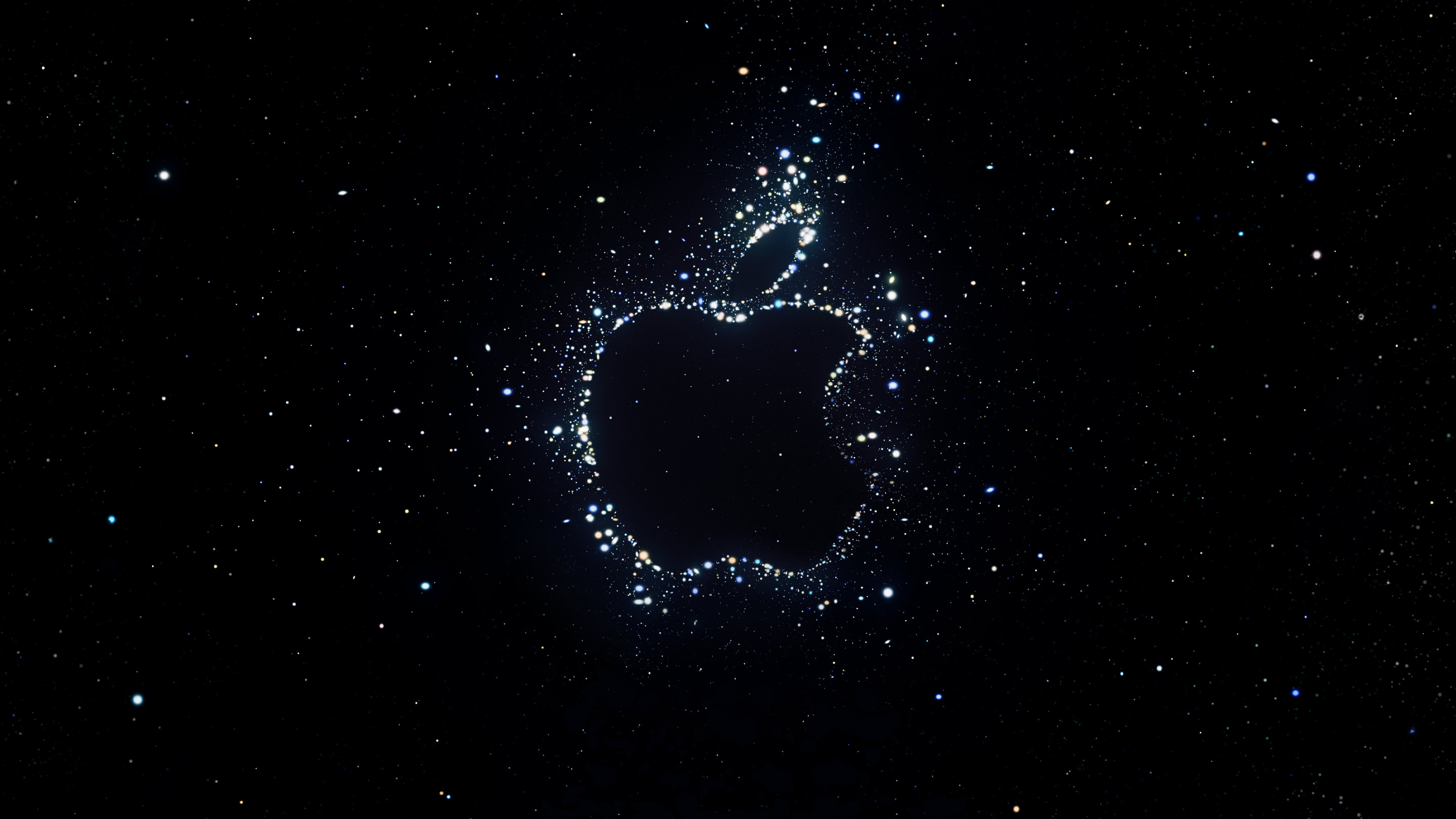 Silhouette of the Apple logo made out of star clusters on a black background.