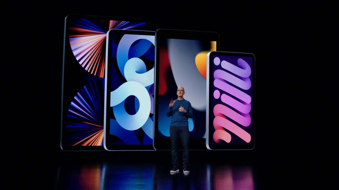 Apple CEO Tim Cook standing in front of four iPad models